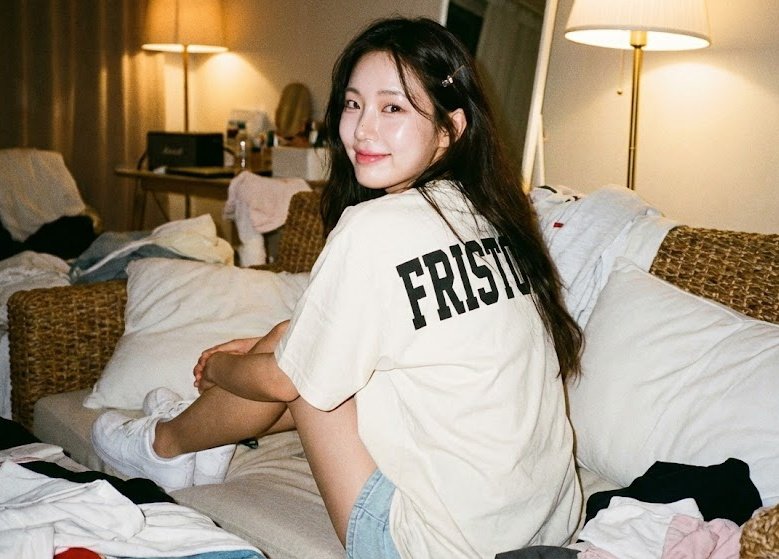 Girl Sitting Backwards on Woven Sofa
